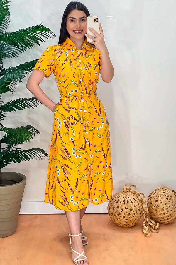 Yellow printed dress with functional buttons, pockets, and guipure lace details